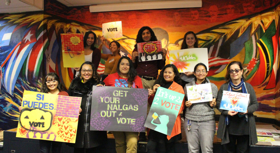 artists, students, and staff holding voting posters