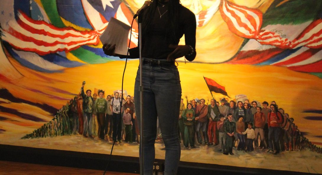 featured poet Ayoko Djisseglo on stage